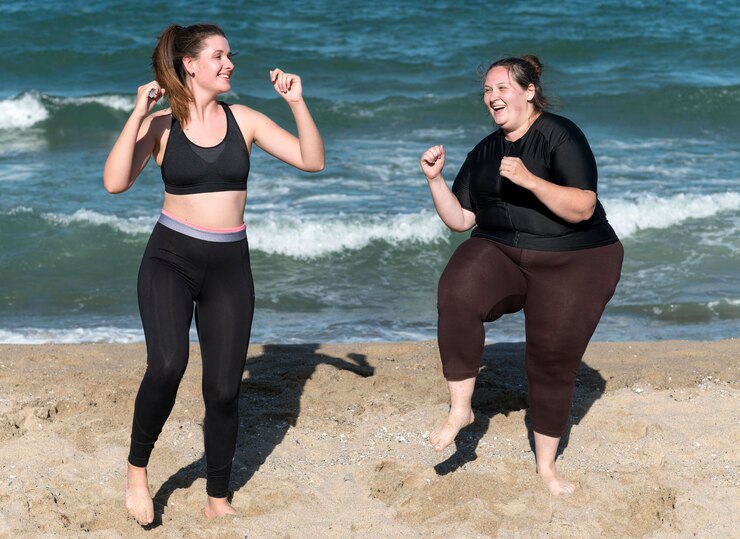 Happy women training together full shot