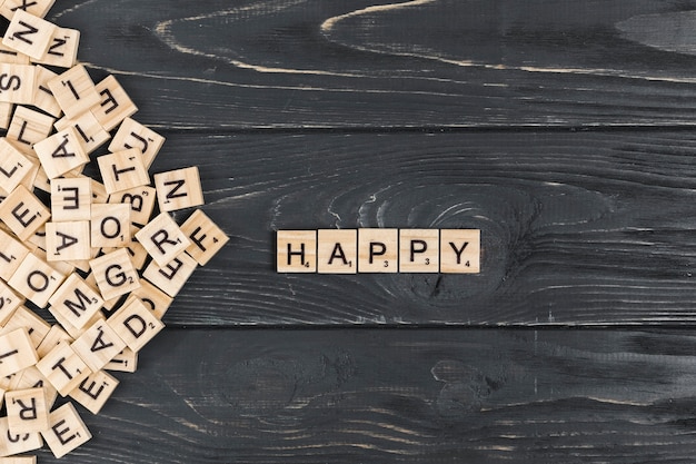 Free photo happy word on wooden background