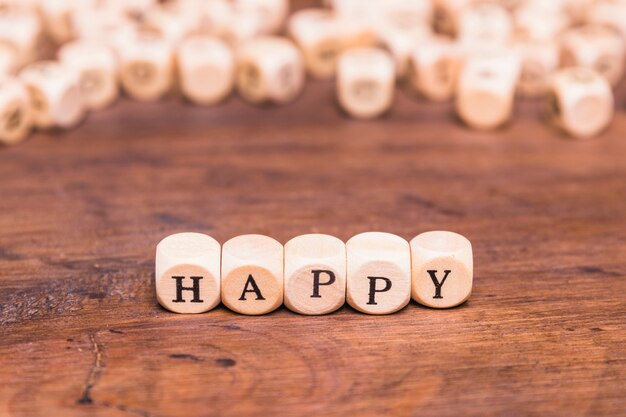 Happy word written on cubes shape wooden blocks