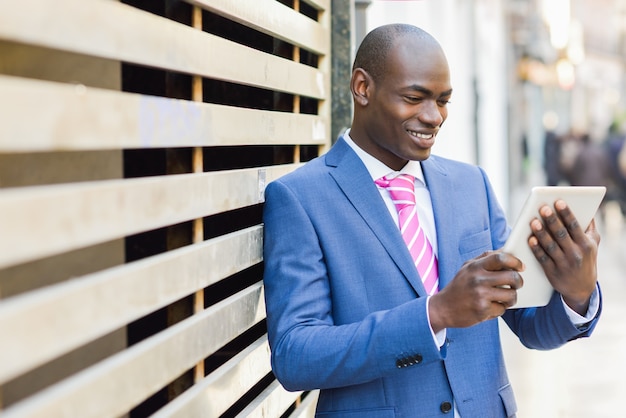 Happy worker checking his mail on the tablet