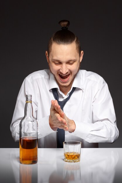 Happy worker with a bottle of whiskey