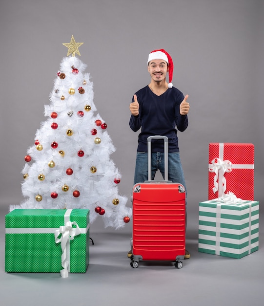 happy xmas man with santa hat showing tumb up sign