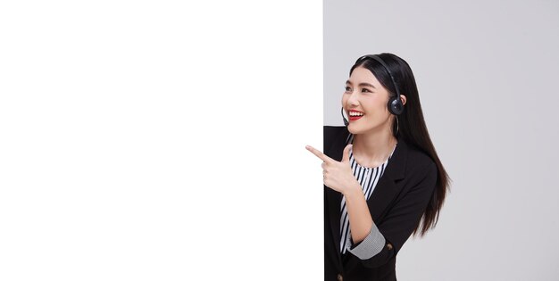 Happy young asian business woman call center pointing presentation blank announcement banner