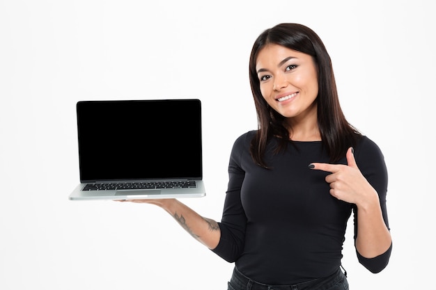 Free photo happy young asian lady showing display of laptop computer