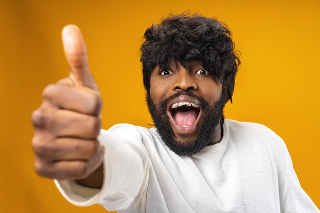 Happy young black man giving thumbs up