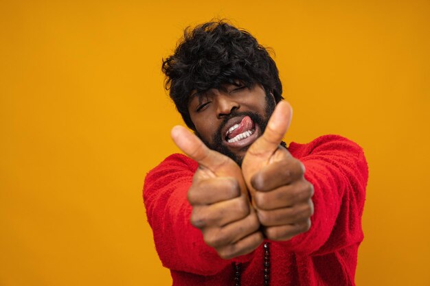 Happy young black man giving thumbs up