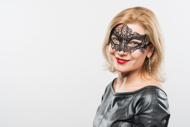 Happy young blond lady in mask