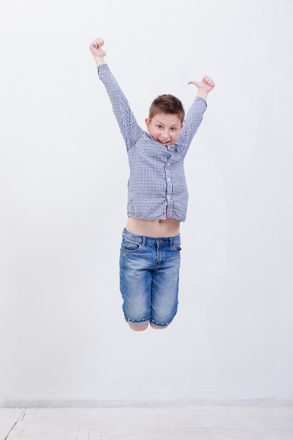 Free photo happy young boy jumping  on white background