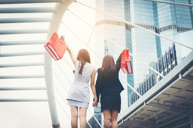 Happy young Business Woman holding shopping bags.