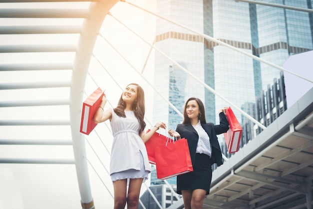 買い物袋を持つ幸せな若いビジネスの女性。