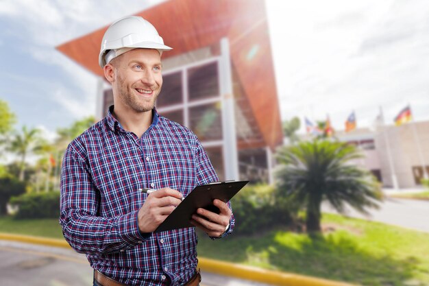 Happy young businessman architect smiling