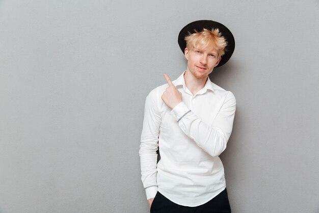 Happy young caucasian man standing isolated