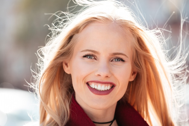 Free photo happy young caucasian woman walking outdoors