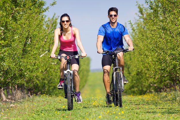 Happy young  couple on a bike ride in the countryside