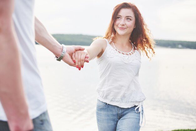 Happy young couple enjoying a solitary beach backriding