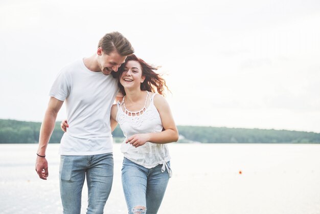 Happy young couple enjoying a solitary beach backriding