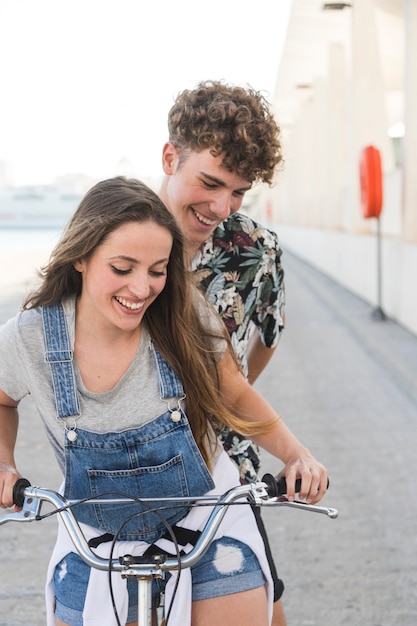 自転車に乗っている間楽しんでいる幸せな若いカップル