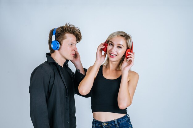 happy young couple in headphones listening music 