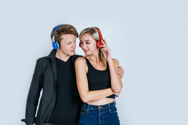 happy young couple in headphones listening music 