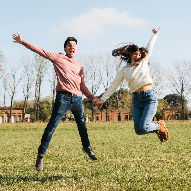 Happy young couple jumping