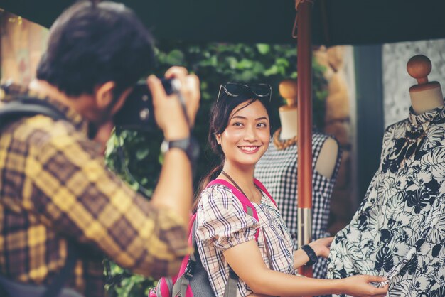 Happy young couple in love takes selfie portrait on the main street 