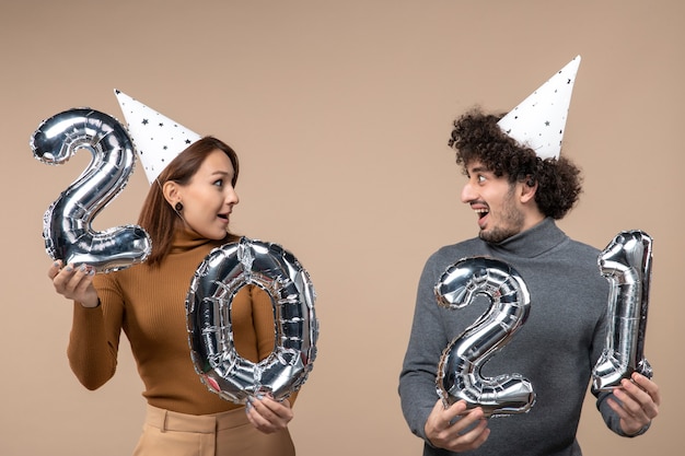 Happy young couple wear new year hat poses for camera Girl