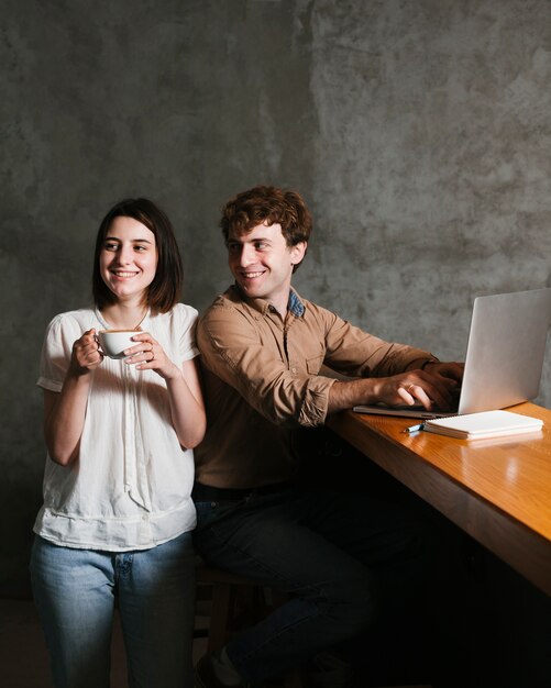 Happy young couple working on laptop