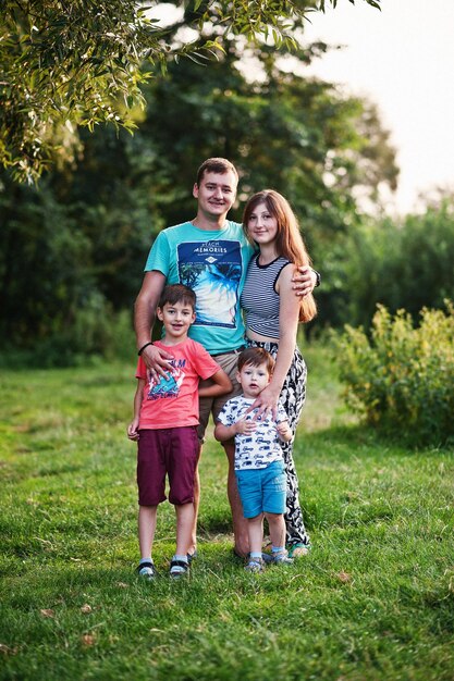 Happy young family mother father two children son on nature having fun