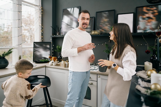 Happy young family spending time together in kitchen at home at christmas