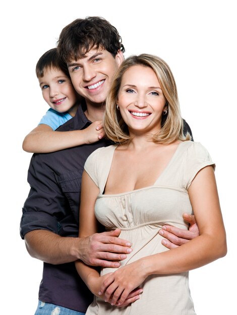 Happy young family with pretty child posing on white space