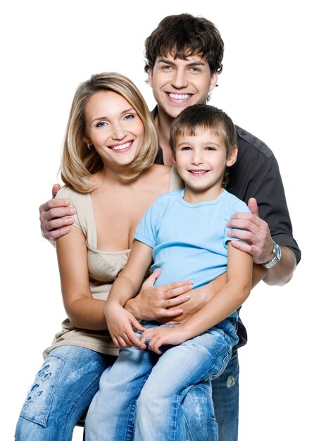 Happy young family with pretty child posing on white space