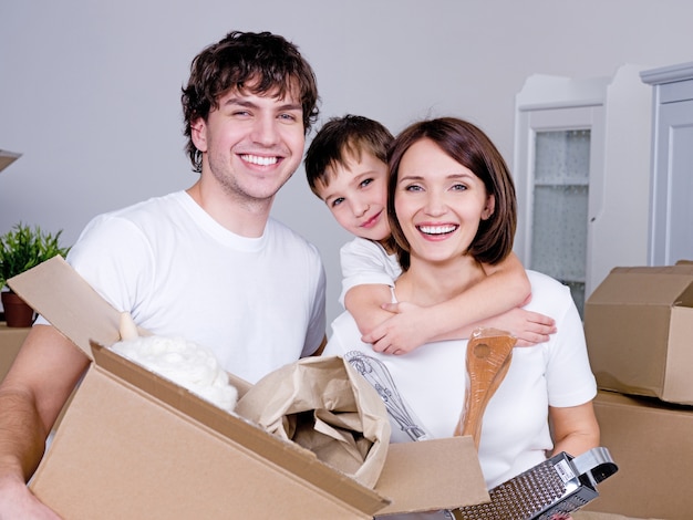 Happy young friendly family in their new flat