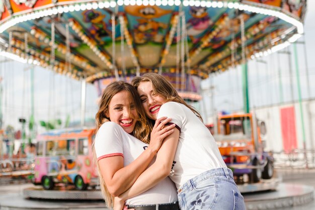 Happy young friends in the amusement park