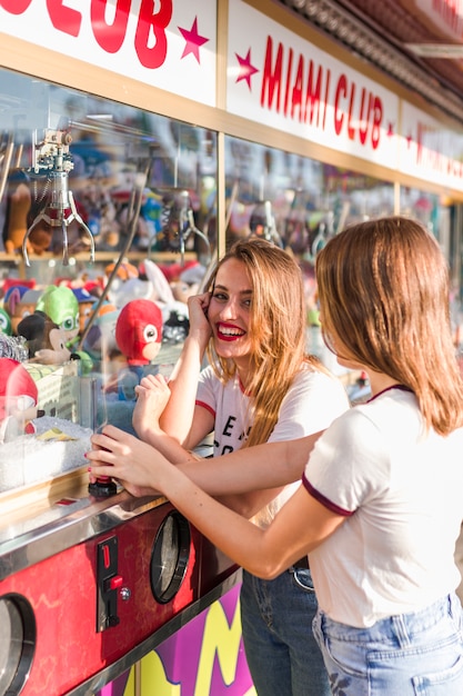 Free photo happy young friends in the amusement park