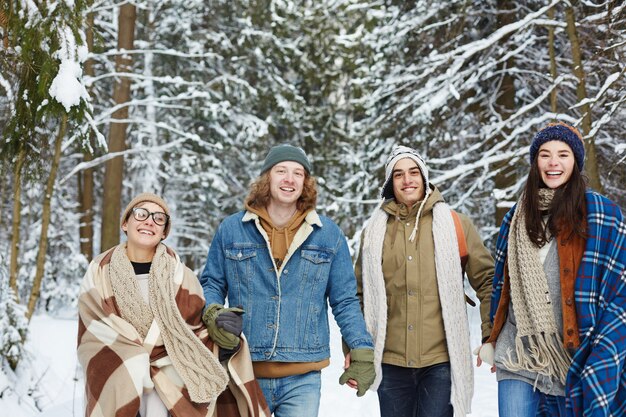 Happy Young Friends in Winter Forest