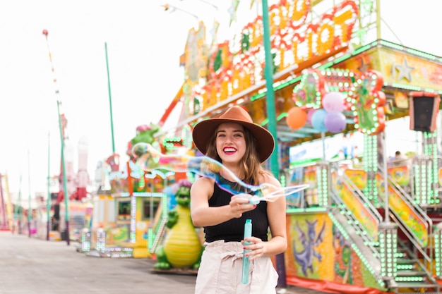 Happy young girl in the amusement park