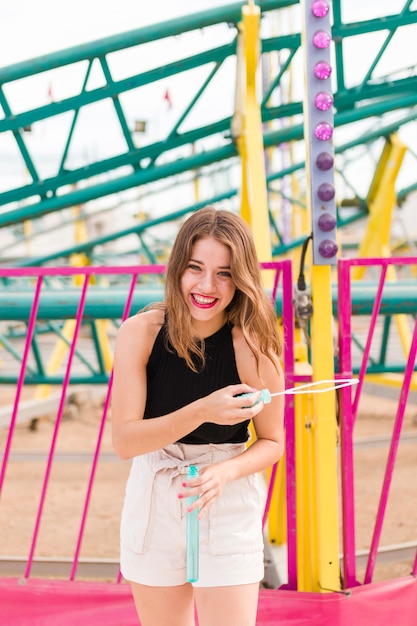 Happy young girl in the amusement park