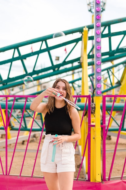 Happy young girl in the amusement park