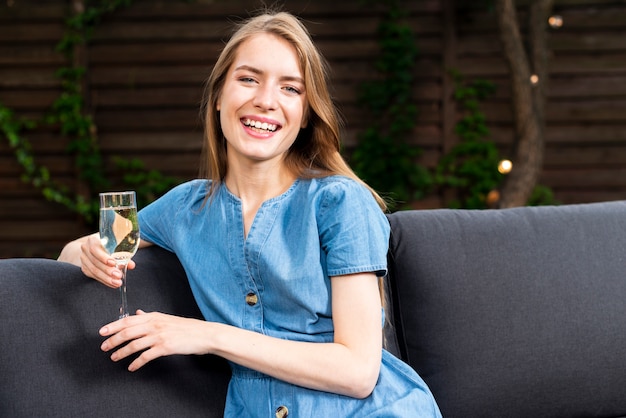 Happy young girl holding a champagne glass