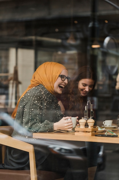 Free photo happy young girl laughing with friends