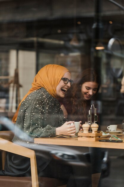 Happy young girl laughing with friends