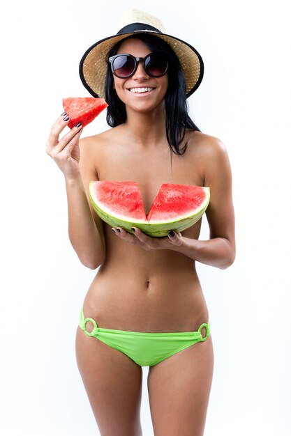 Happy Young girl in topless, eating a watermelon