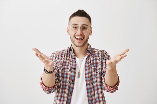 Happy young guy with glasses posing