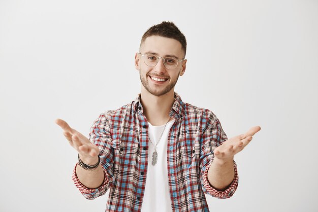 Happy young guy with glasses posing