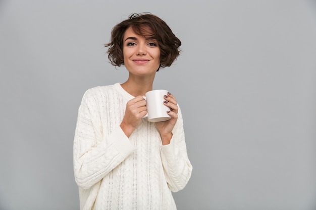 お茶を飲んで幸せな若い女性。