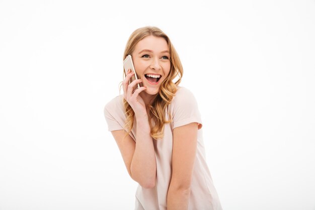 携帯電話で話している幸せな若い女性。
