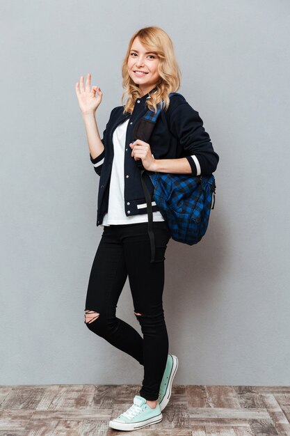 Happy young lady with backpack