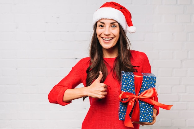 Free photo happy young lady with present box showing good