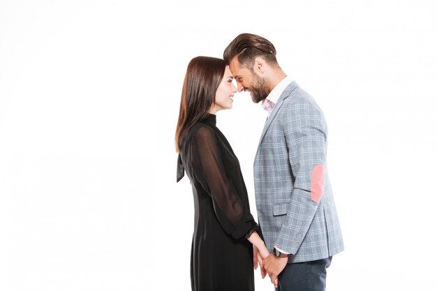 Happy young loving couple standing isolated