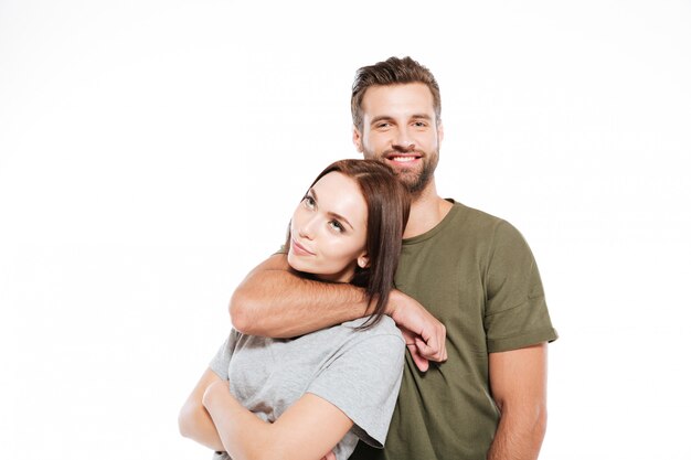 Happy young loving couple standing isolated